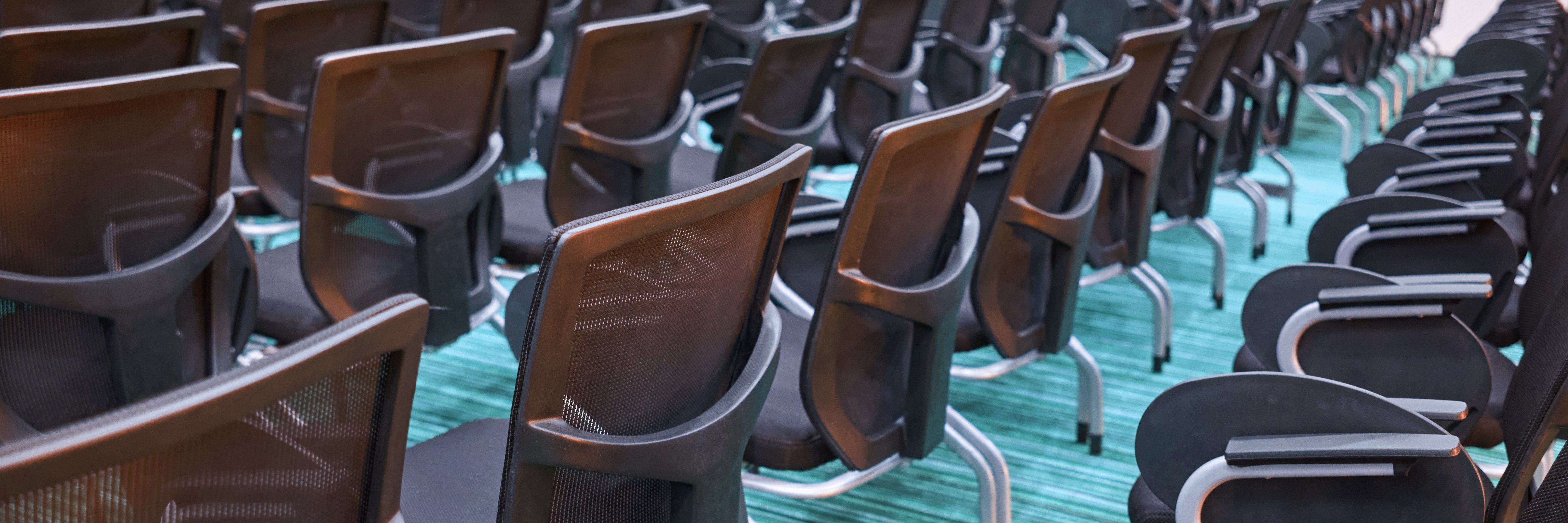 empty-conference-room-with-rows-of-black-chairs-on-2026-03-27-00-48-53-utc
